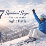 Woman celebrating after skiing down a mountain representing spiritual signs you are on the right path
